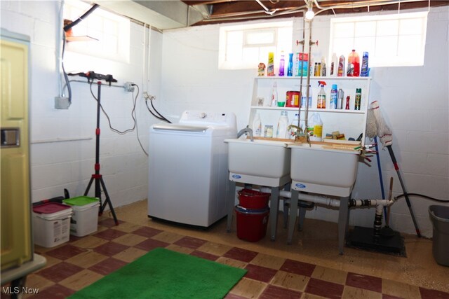 washroom with washer / clothes dryer, tile patterned floors, and concrete block wall