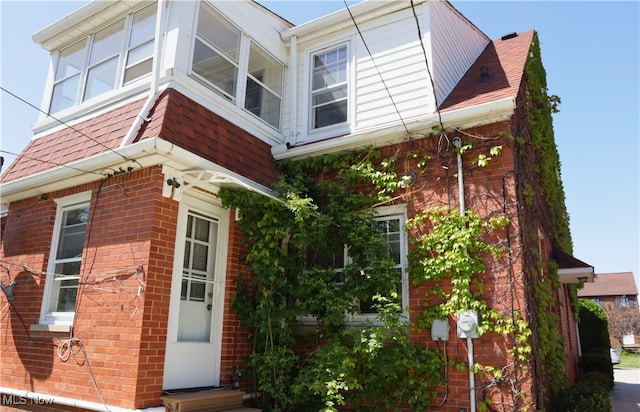 view of side of property featuring brick siding
