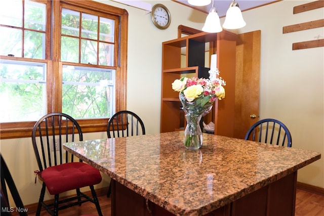 dining area with wood finished floors and baseboards