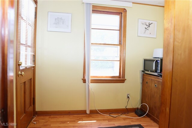 interior space featuring light wood-style flooring and baseboards