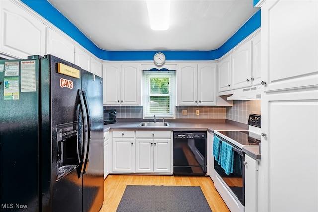 21494 Mastick Rd, Fairview Park, OH 44126 - kitchen with black appliances, a sink, under cabinet range hood, light wood finished floors, and white cabinets
