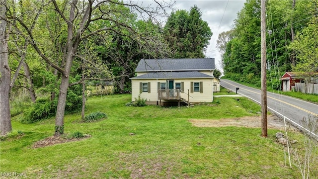 8055 Dolphin St SW, Bolivar, OH 44612 - view of front of house with a front yard and roof with shingles