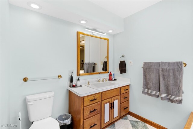 218 Tanglewood Dr, Dalton, OH 44618 - bathroom with toilet, vanity, recessed lighting, and baseboards