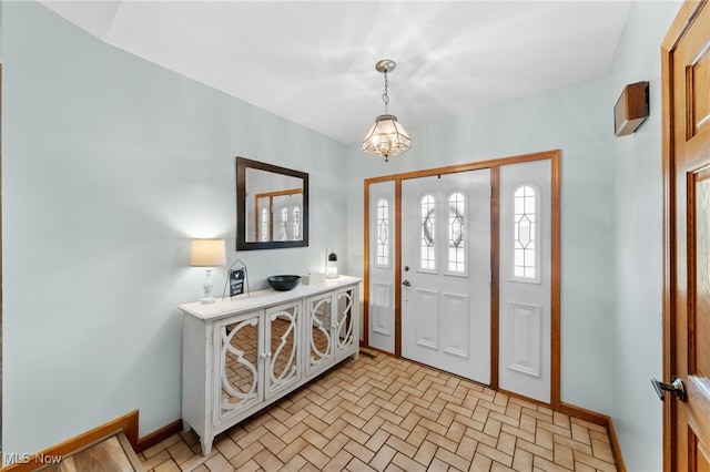 218 Tanglewood Dr, Dalton, OH 44618 - entrance foyer featuring baseboards and a chandelier
