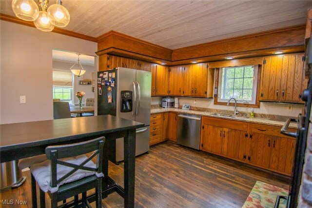 45 S Ridge Dr, Martins Ferry, OH 43935 - kitchen featuring appliances with stainless steel finishes, a sink, brown cabinetry, dark wood-type flooring, and a chandelier