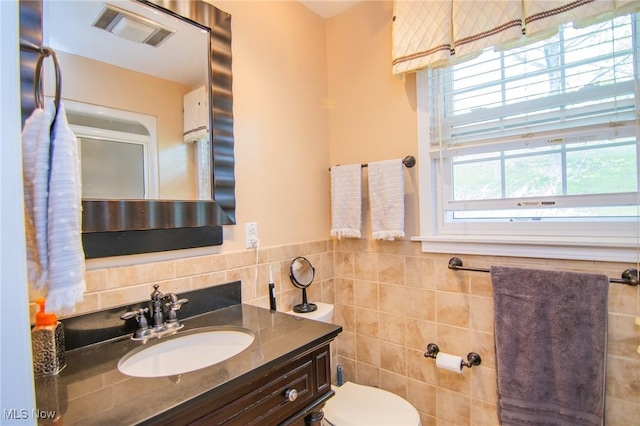 45 S Ridge Dr, Martins Ferry, OH 43935 - bathroom featuring tile walls, toilet, vanity, and wainscoting