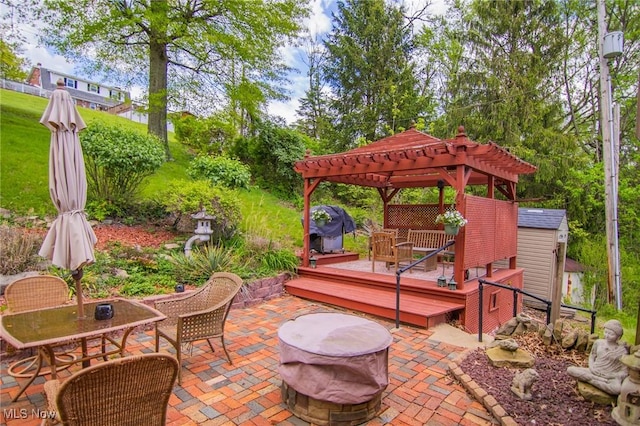 45 S Ridge Dr, Martins Ferry, OH 43935 - view of patio with a pergola, a wooden deck, an outdoor fire pit, a storage unit, and an outbuilding