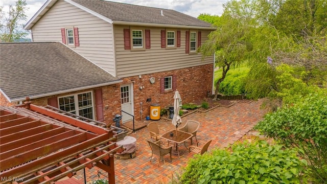 45 S Ridge Dr, Martins Ferry, OH 43935 - back of property featuring a patio area, roof with shingles, and brick siding