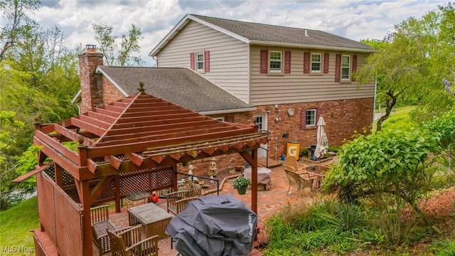 45 S Ridge Dr, Martins Ferry, OH 43935 - back of house with a patio, brick siding, a chimney, and a shingled roof
