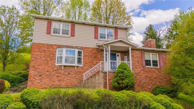 45 S Ridge Dr, Martins Ferry, OH 43935 - traditional-style house with a chimney and brick siding