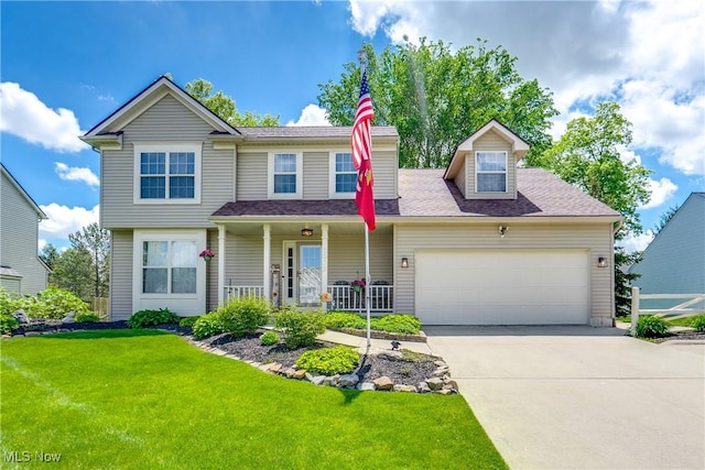 view of front of home with a front lawn, an attached garage, concrete driveway, and a porch