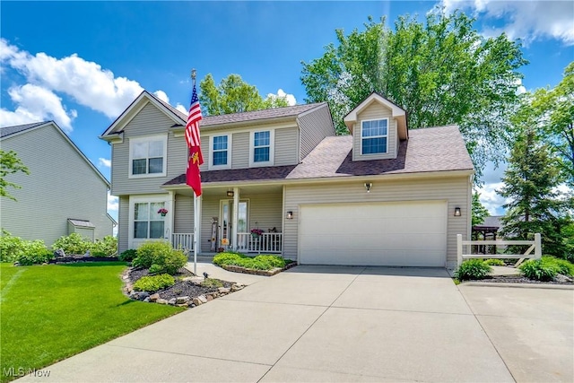 view of front of house featuring a porch, a front yard, an attached garage, driveway, and a shingled roof