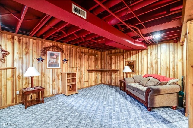 living area featuring carpet flooring, wood walls, and baseboards