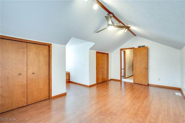 additional living space featuring vaulted ceiling, ceiling fan, light wood finished floors, and baseboards