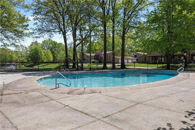 community pool featuring a patio and fence