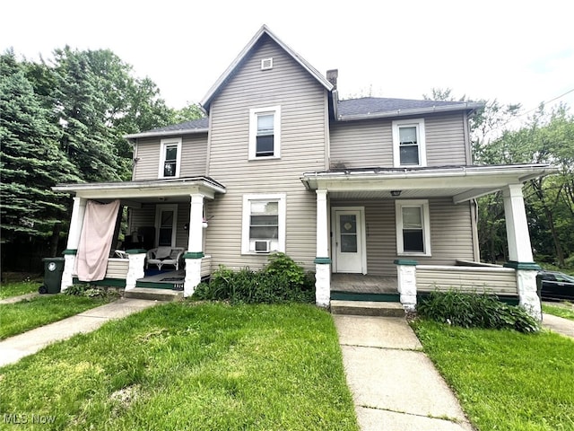 1312 12th St NE, Canton, OH 44705 - view of front of property featuring a porch, a front lawn, cooling unit, a shingled roof, and a chimney