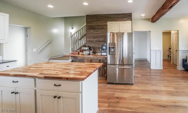 7841 State St NE, Louisville, OH 44641 - kitchen with stainless steel fridge with ice dispenser, butcher block countertops, light wood-style floors, white cabinetry, and recessed lighting