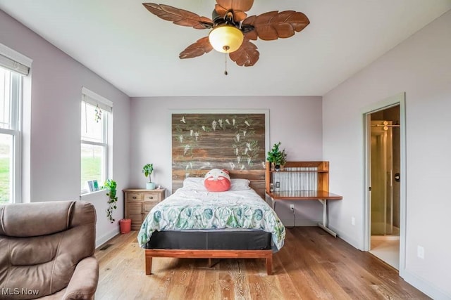 7841 State St NE, Louisville, OH 44641 - bedroom with wood finished floors, baseboards, ceiling fan, and ensuite bath