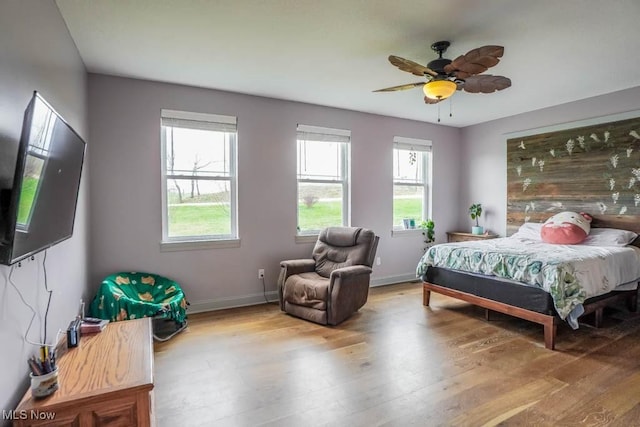 7841 State St NE, Louisville, OH 44641 - bedroom with wood finished floors, baseboards, and ceiling fan