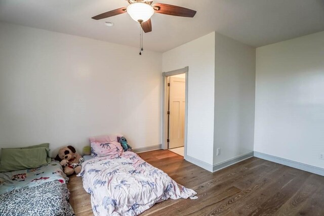 7841 State St NE, Louisville, OH 44641 - bedroom with wood finished floors, baseboards, and ceiling fan