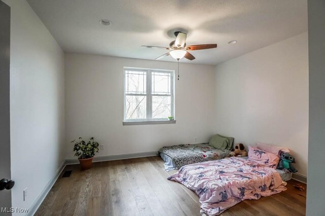 7841 State St NE, Louisville, OH 44641 - bedroom with wood finished floors, baseboards, and ceiling fan