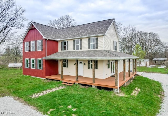 7841 State St NE, Louisville, OH 44641 - farmhouse inspired home with covered porch, a front yard, and roof with shingles