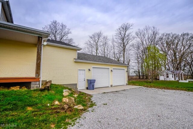 7841 State St NE, Louisville, OH 44641 - garage with gravel driveway