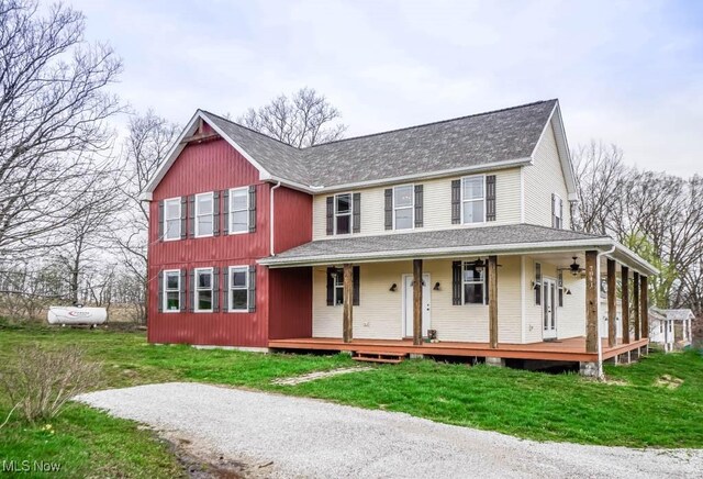 7841 State St NE, Louisville, OH 44641 - farmhouse-style home with a front yard, a shingled roof, and a porch