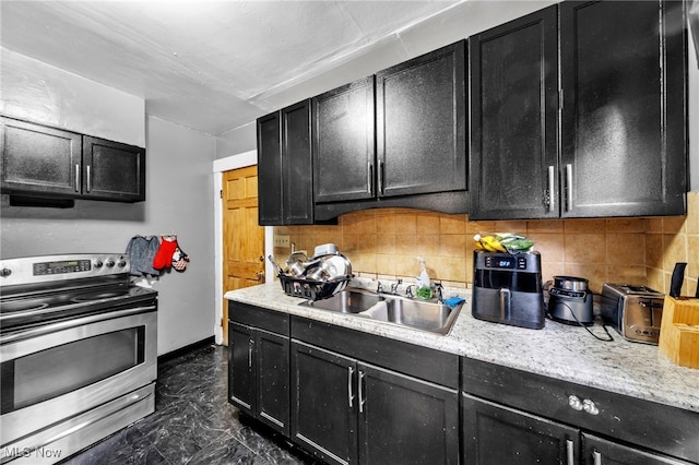 3741 E 146th St, Cleveland, OH 44120 - kitchen with stainless steel electric range oven, dark cabinets, a sink, and dark marble finish flooring