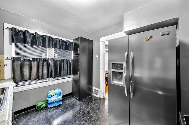 3741 E 146th St, Cleveland, OH 44120 - kitchen featuring stainless steel fridge with ice dispenser, dark cabinets, and baseboards