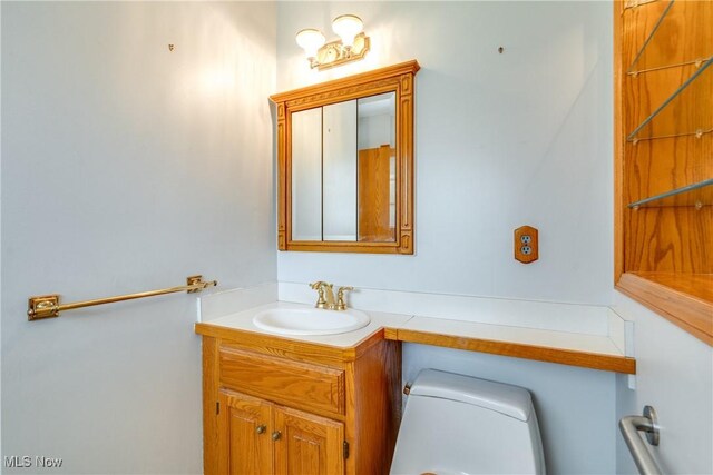 half bathroom featuring toilet and vanity