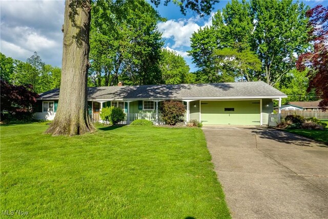 ranch-style house with a porch, concrete driveway, and a chimney