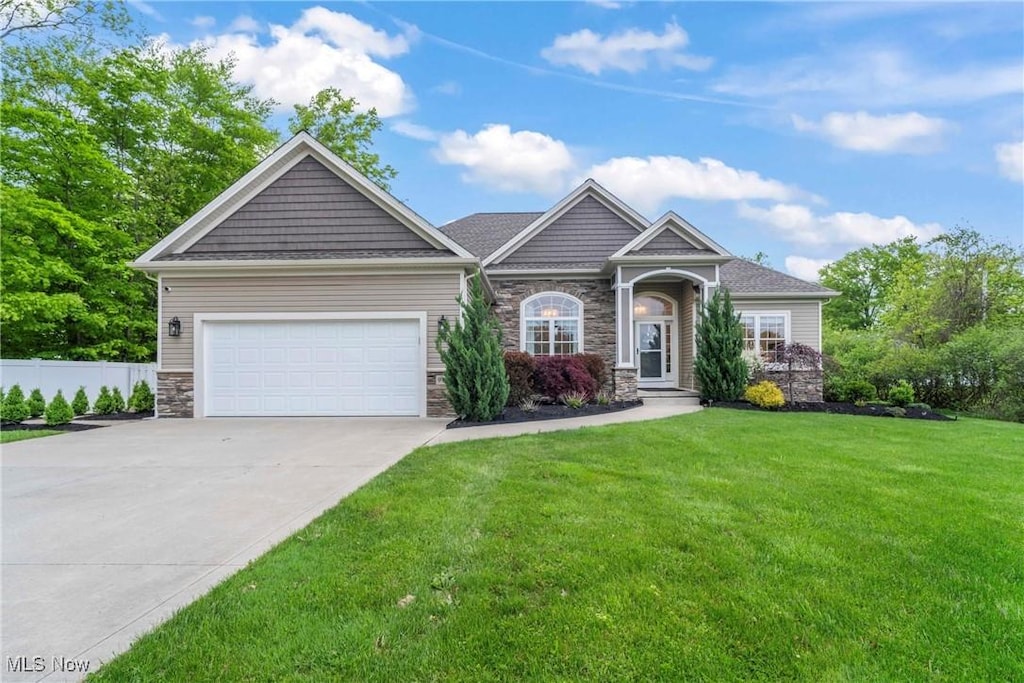 9475 Johnnycake Ridge Rd, Mentor, OH 44060 - craftsman-style home featuring stone siding, driveway, and a garage