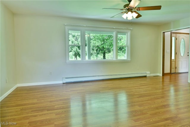 unfurnished living room featuring a baseboard heating unit, light wood-style floors, ceiling fan, and baseboards