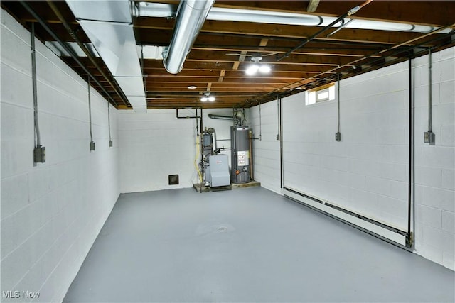 below grade area featuring water heater, a baseboard heating unit, and concrete block wall