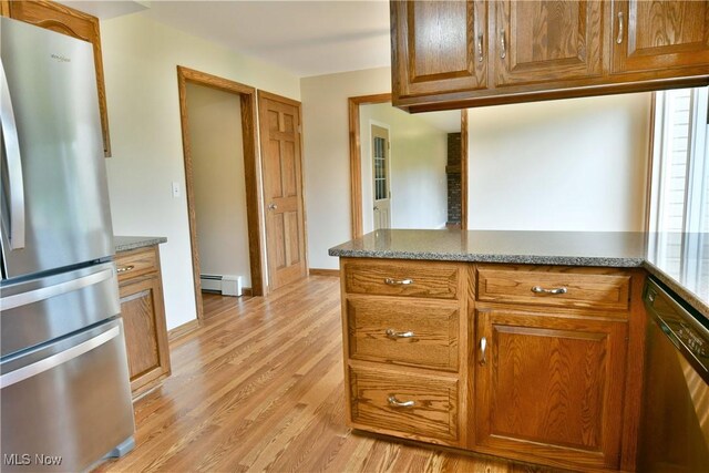 kitchen featuring appliances with stainless steel finishes, baseboard heating, light wood-style floors, and brown cabinetry