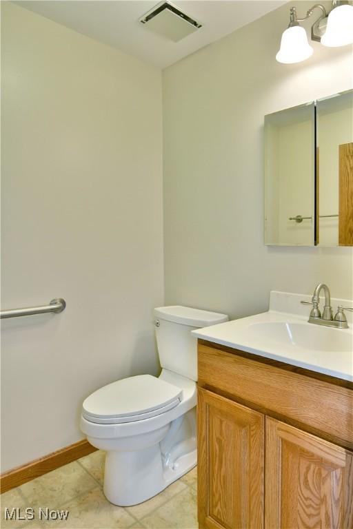bathroom with toilet and vanity