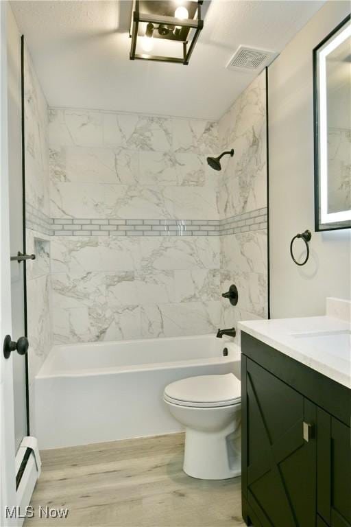 bathroom with a baseboard heating unit, shower / tub combination, wood finished floors, toilet, and vanity