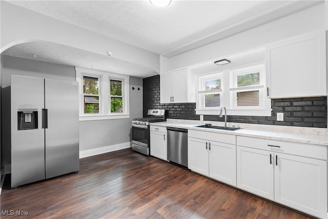 453 Saint Leger Ave, Akron, OH 44305 - kitchen featuring appliances with stainless steel finishes, a sink, dark wood-style flooring, decorative backsplash, and a textured ceiling