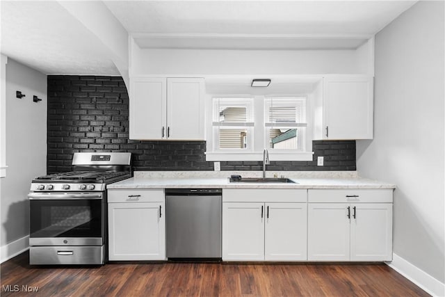 453 Saint Leger Ave, Akron, OH 44305 - kitchen with appliances with stainless steel finishes, a sink, backsplash, white cabinetry, and dark wood-type flooring