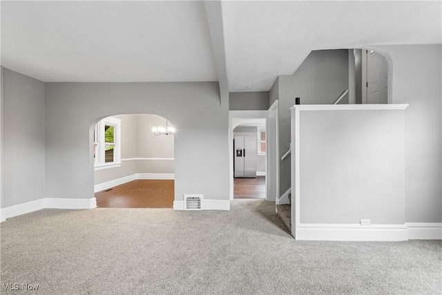 453 Saint Leger Ave, Akron, OH 44305 - unfurnished room with arched walkways, carpet, stairway, and baseboards