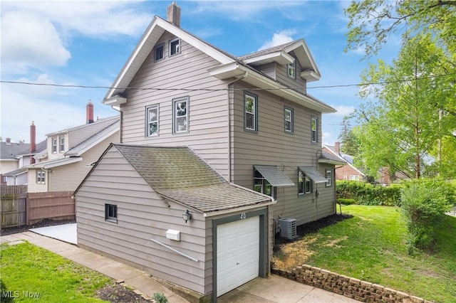 453 Saint Leger Ave, Akron, OH 44305 - view of side of property featuring a garage, cooling unit, a chimney, and concrete driveway