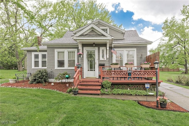 1240 Elmwood Rd, Mayfield Heights, OH 44124 - view of front facade featuring a front yard, a deck, and roof with shingles