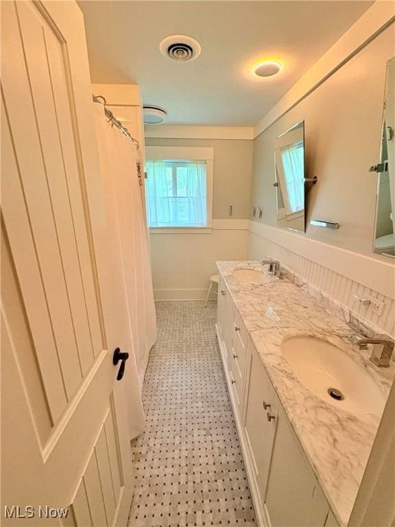 3569 N Karwood Dr, Port Clinton, OH 43452 - full bath featuring double vanity, tile patterned floors, and a shower with shower curtain