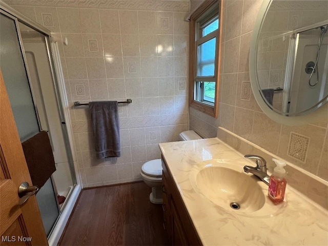 2165 Stony Hill Rd, Hinckley, OH 44233 - full bath with tile walls, toilet, wood finished floors, a stall shower, and vanity