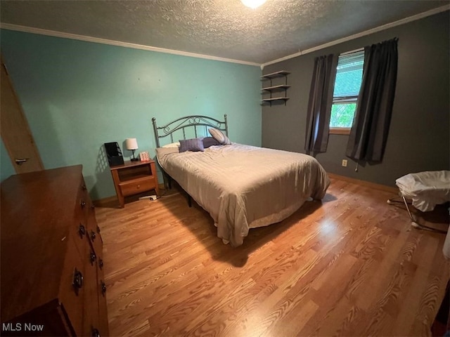 2165 Stony Hill Rd, Hinckley, OH 44233 - bedroom with ornamental molding, light wood finished floors, a textured ceiling, and baseboards