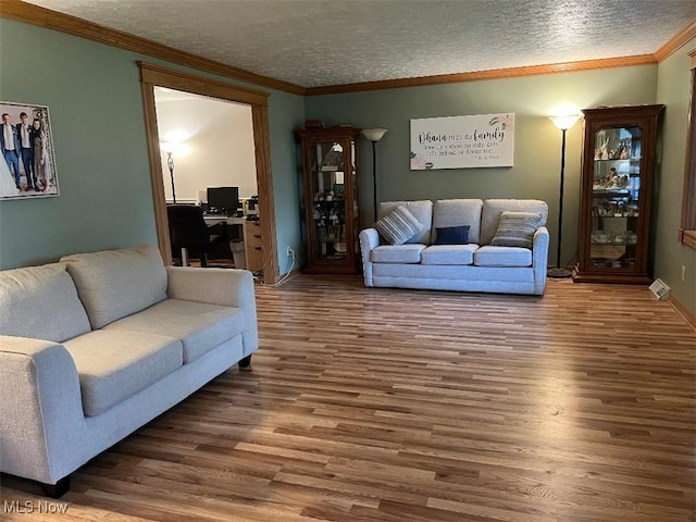 2165 Stony Hill Rd, Hinckley, OH 44233 - living room featuring wood finished floors, a textured ceiling, ornamental molding, and baseboards