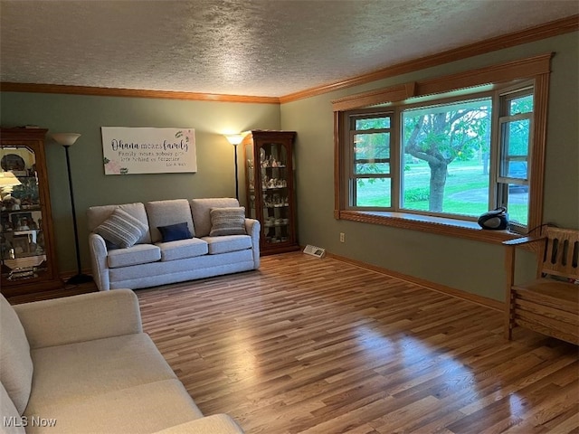 2165 Stony Hill Rd, Hinckley, OH 44233 - living room with ornamental molding, wood finished floors, baseboards, and a textured ceiling