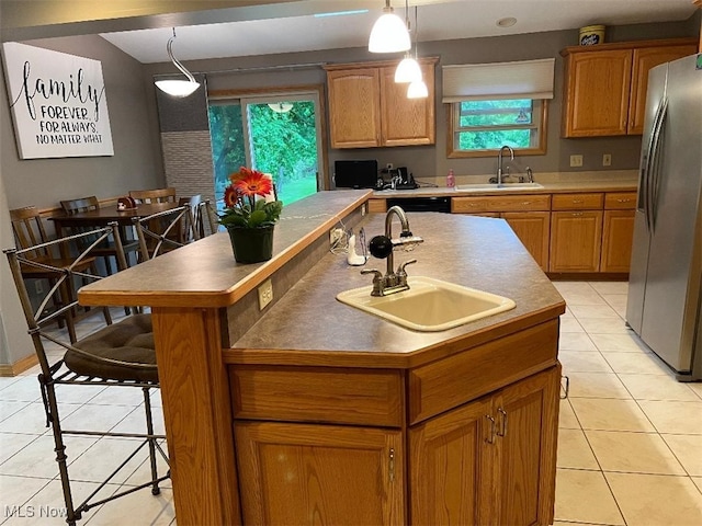 2165 Stony Hill Rd, Hinckley, OH 44233 - kitchen featuring stainless steel refrigerator with ice dispenser, a sink, light tile patterned flooring, and a center island