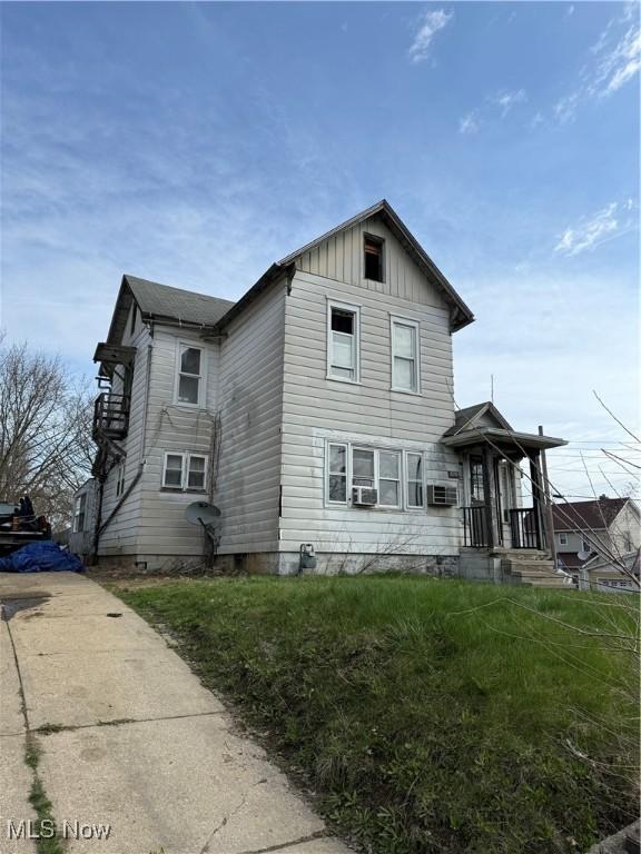 820 Milner St, Alliance, OH 44601 - view of front facade with cooling unit and board and batten siding